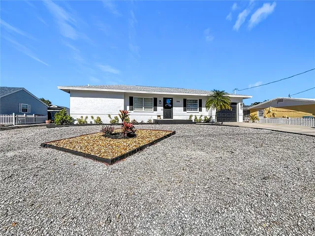 a aerial view of a house with swimming pool and a yard
