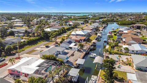 an aerial view of residential building with outdoor space and seating