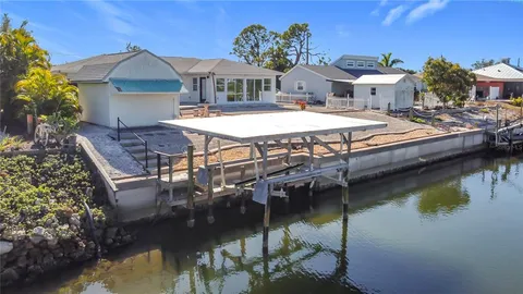 a view of a house with pool and chairs