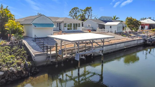 a view of a house with pool and chairs