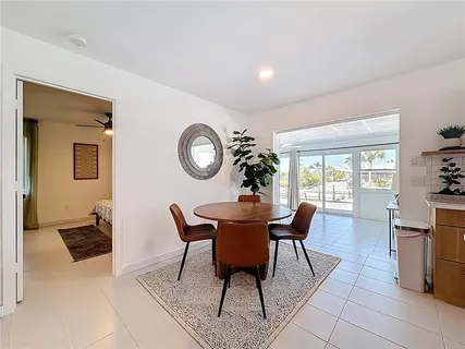 a view of a dining room with furniture and a large window