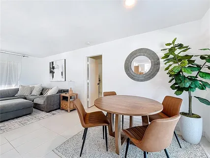 a living room with furniture a rug and a window
