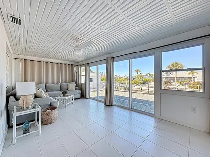 a living room with furniture and large windows