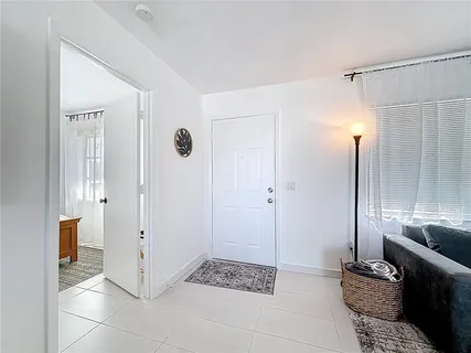 a walk in closet and view of bathroom