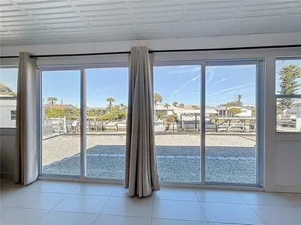 an aerial view of residential houses with outdoor space and river