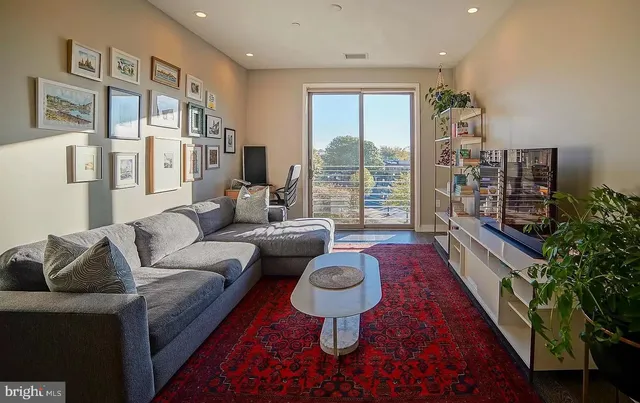 a living room with furniture and a floor to ceiling window