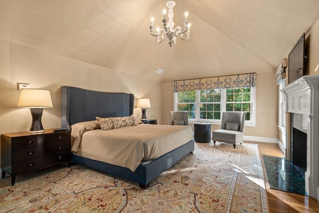 84 Old Colony Road Wellesley, MA 02481 - Photo 19 of 39 a bedroom with a large bed and a chandelier