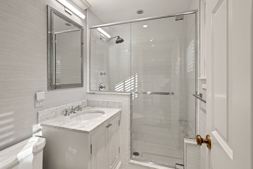 84 Old Colony Road Wellesley, MA 02481 - Photo 26 of 39 a bathroom with a shower sink vanity and mirror