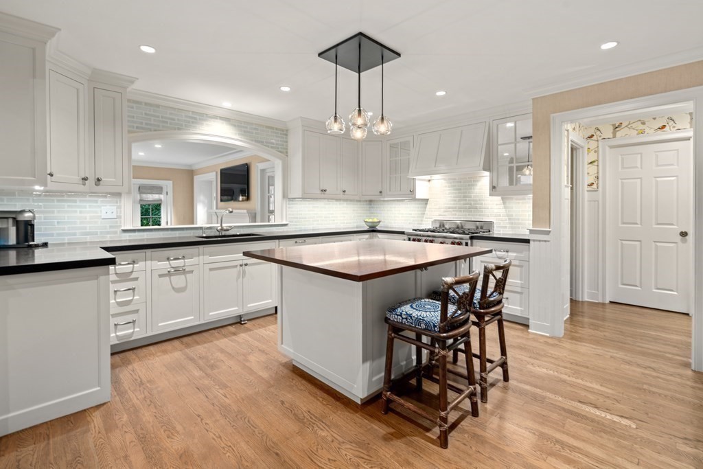 84 Old Colony Road Wellesley, MA 02481 - Photo 3 of 39 a kitchen with stainless steel appliances granite countertop a sink a stove a dining table and chairs