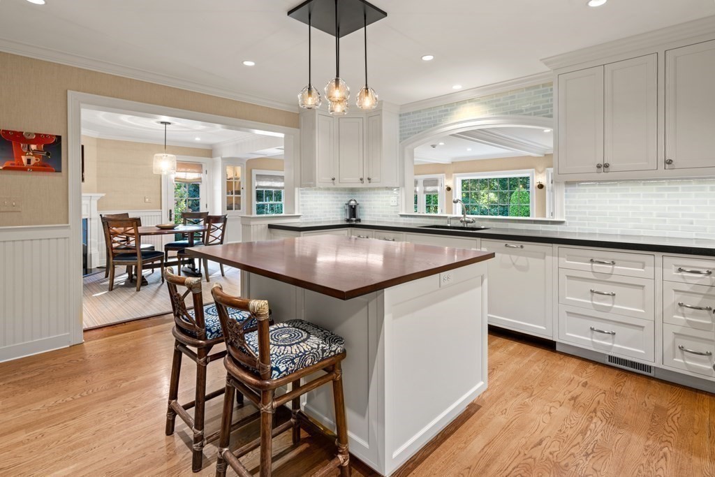 84 Old Colony Road Wellesley, MA 02481 - Photo 5 of 39 a kitchen with granite countertop a table chairs stove and cabinets