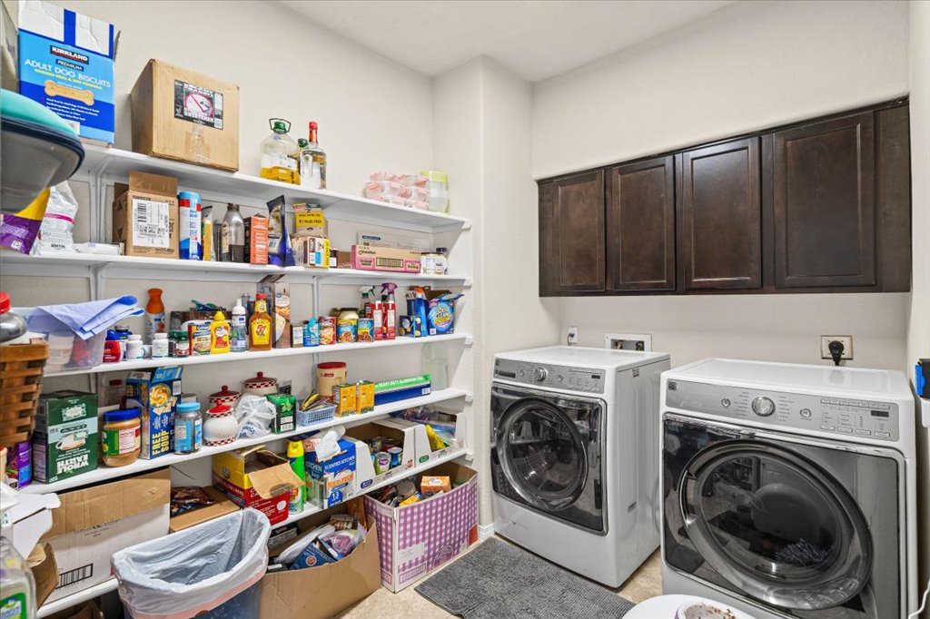 212 Plata Lane Jarrell, TX 76537 - Photo 13 of 29 Laundry room featuring cabinet space and washer and dryer