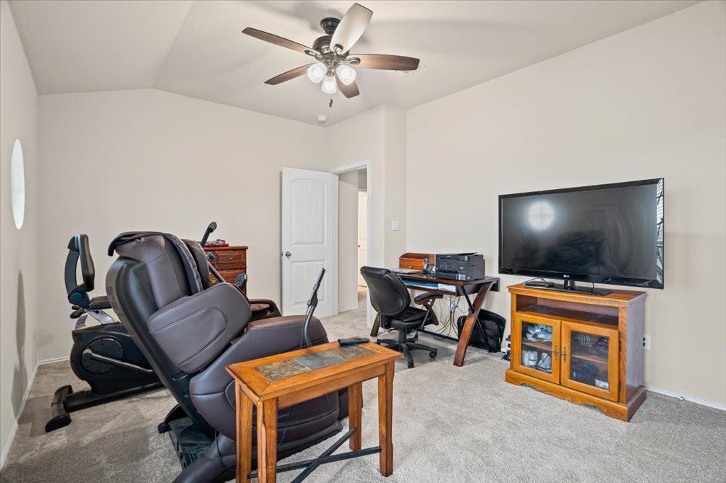 212 Plata Lane Jarrell, TX 76537 - Photo 15 of 29 Home office featuring lofted ceiling, light colored carpet, and a ceiling fan