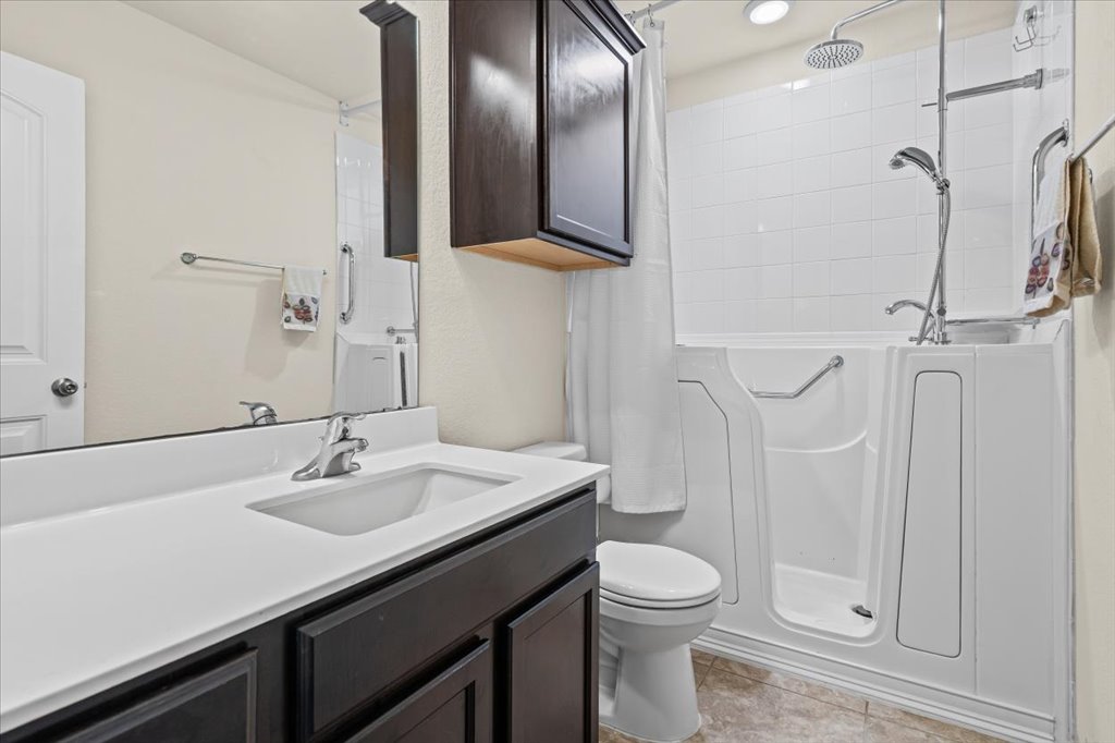 212 Plata Lane Jarrell, TX 76537 - Photo 18 of 29 Bathroom featuring vanity and a shower with curtain