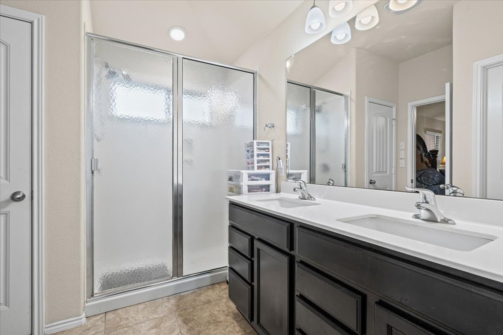 212 Plata Lane Jarrell, TX 76537 - Photo 21 of 29 Bathroom featuring double vanity and a shower stall