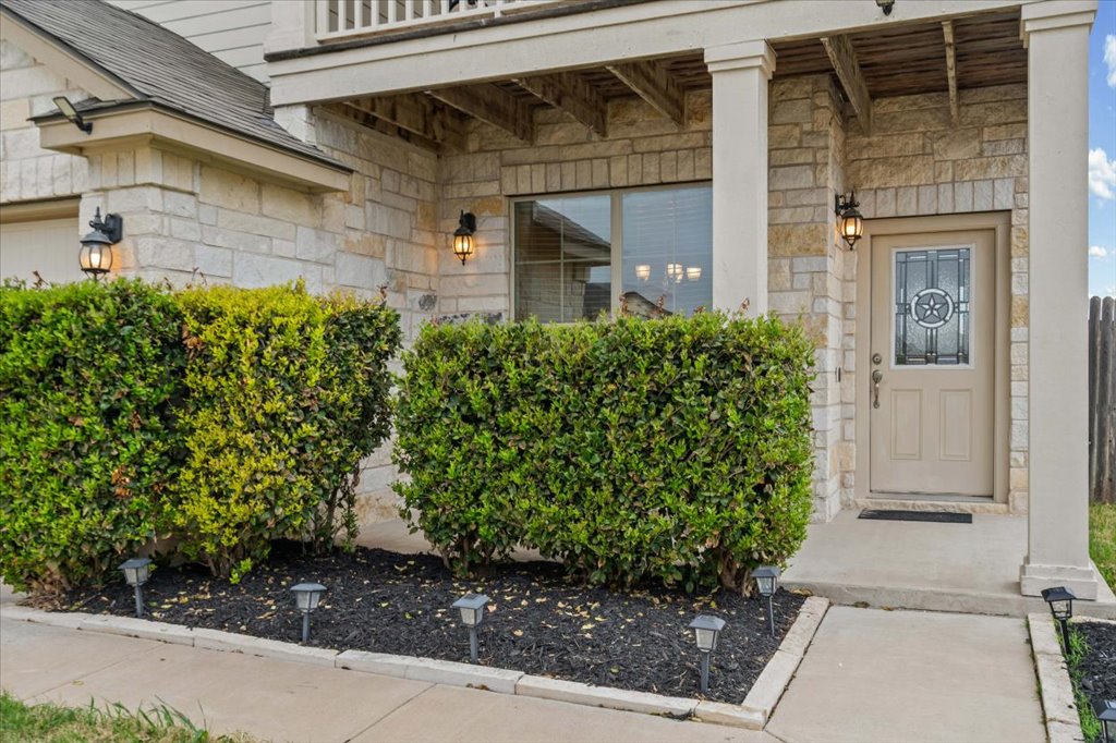 212 Plata Lane Jarrell, TX 76537 - Photo 3 of 29 View of exterior entry featuring stone siding