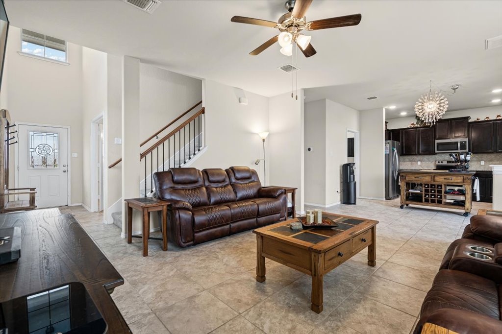 212 Plata Lane Jarrell, TX 76537 - Photo 8 of 29 Living area with hanging lights, ceiling fan, light tile patterned floors, and a high ceiling