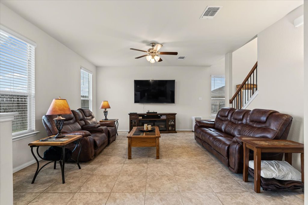 212 Plata Lane Jarrell, TX 76537 - Photo 9 of 29 Living area with a ceiling fan and light tile patterned floors