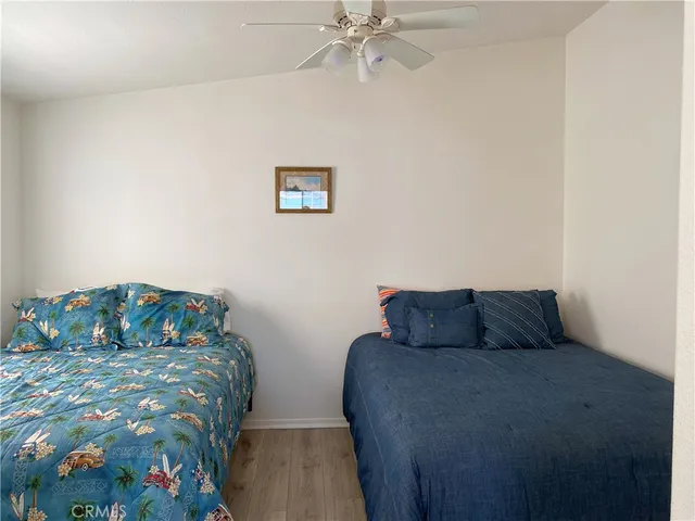 a bedroom with two beds and a baby crib
