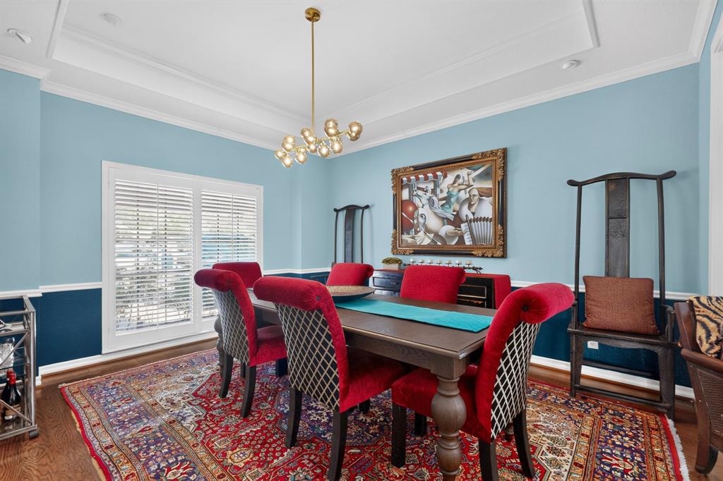 1526 Abrams Road Dallas, TX 75214 - Photo 6 of 38 Hardwood flooring, crown molding, tray ceiling, modern chandelier, and exterior access