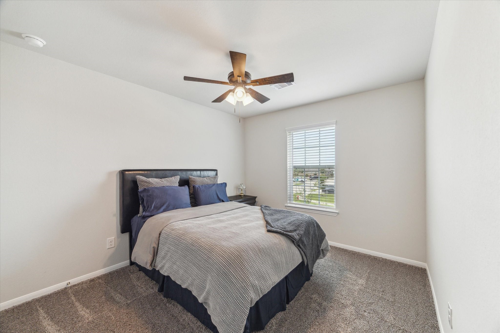 1523 Alpine Drive Rosharon, TX 77583 - Photo 22 of 25 a bedroom with a bed and a chandelier