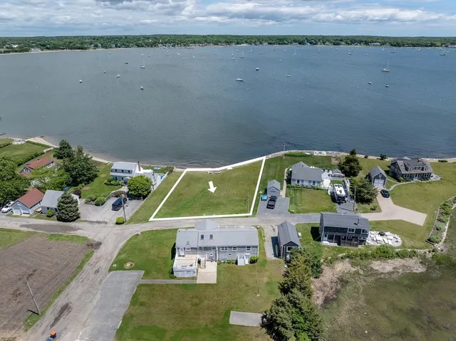 an aerial view of a house with a lake