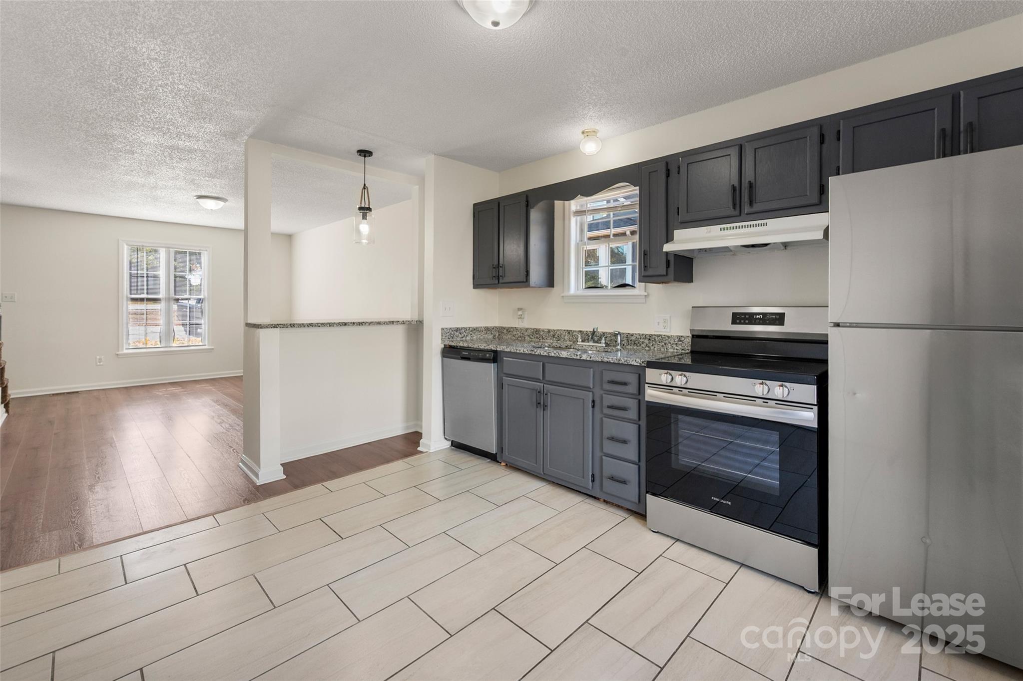 608 Bethpage Road Kannapolis, NC 28081 - Photo 12 of 37 a kitchen with granite countertop a refrigerator and a stove top oven