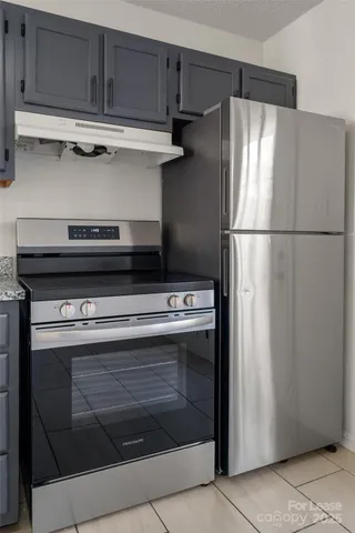 a stove top oven sitting inside of a kitchen