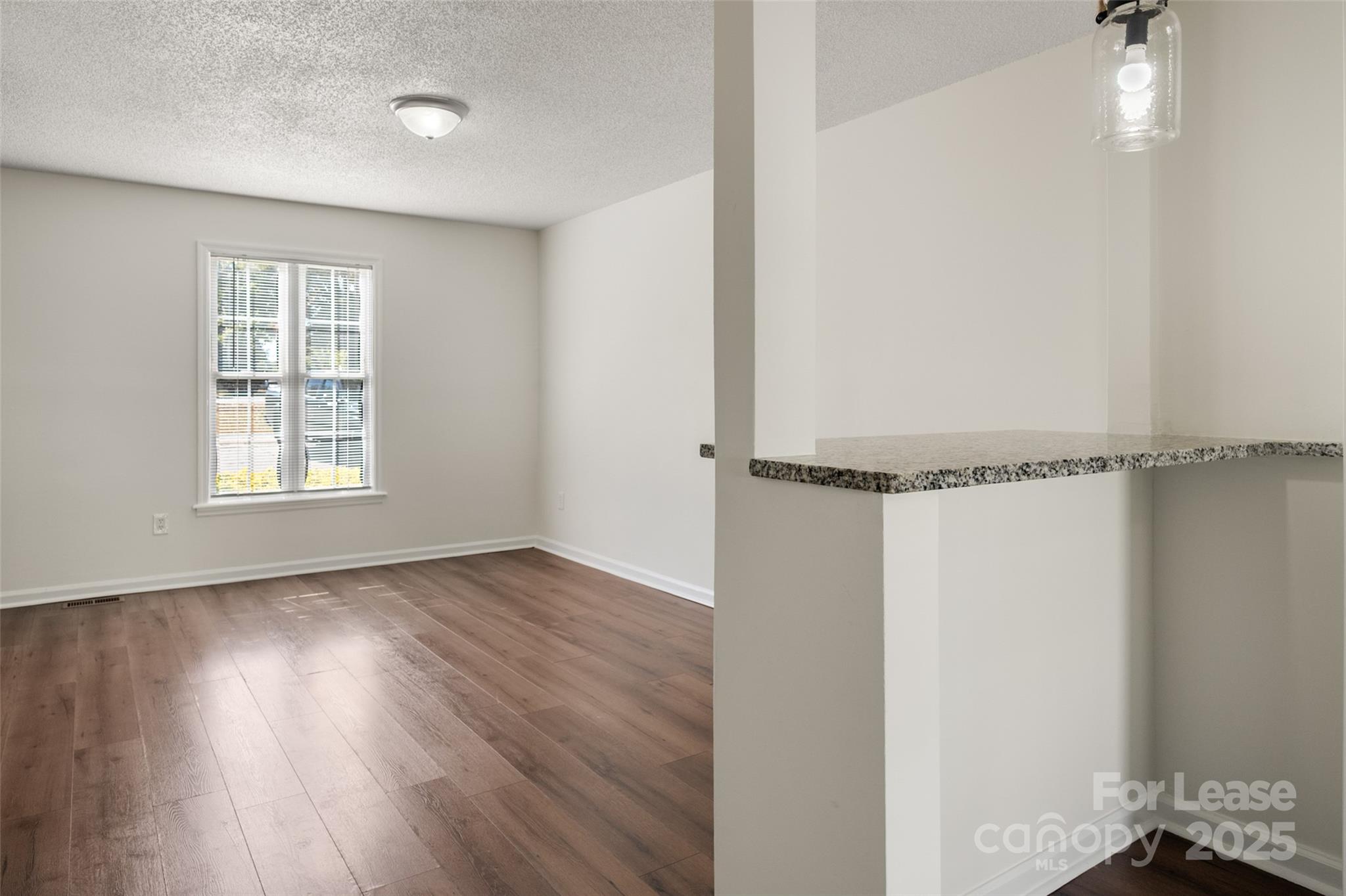 608 Bethpage Road Kannapolis, NC 28081 - Photo 17 of 37 a view of an empty room with wooden floor and a window