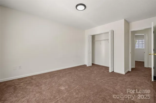 an empty room with closet area