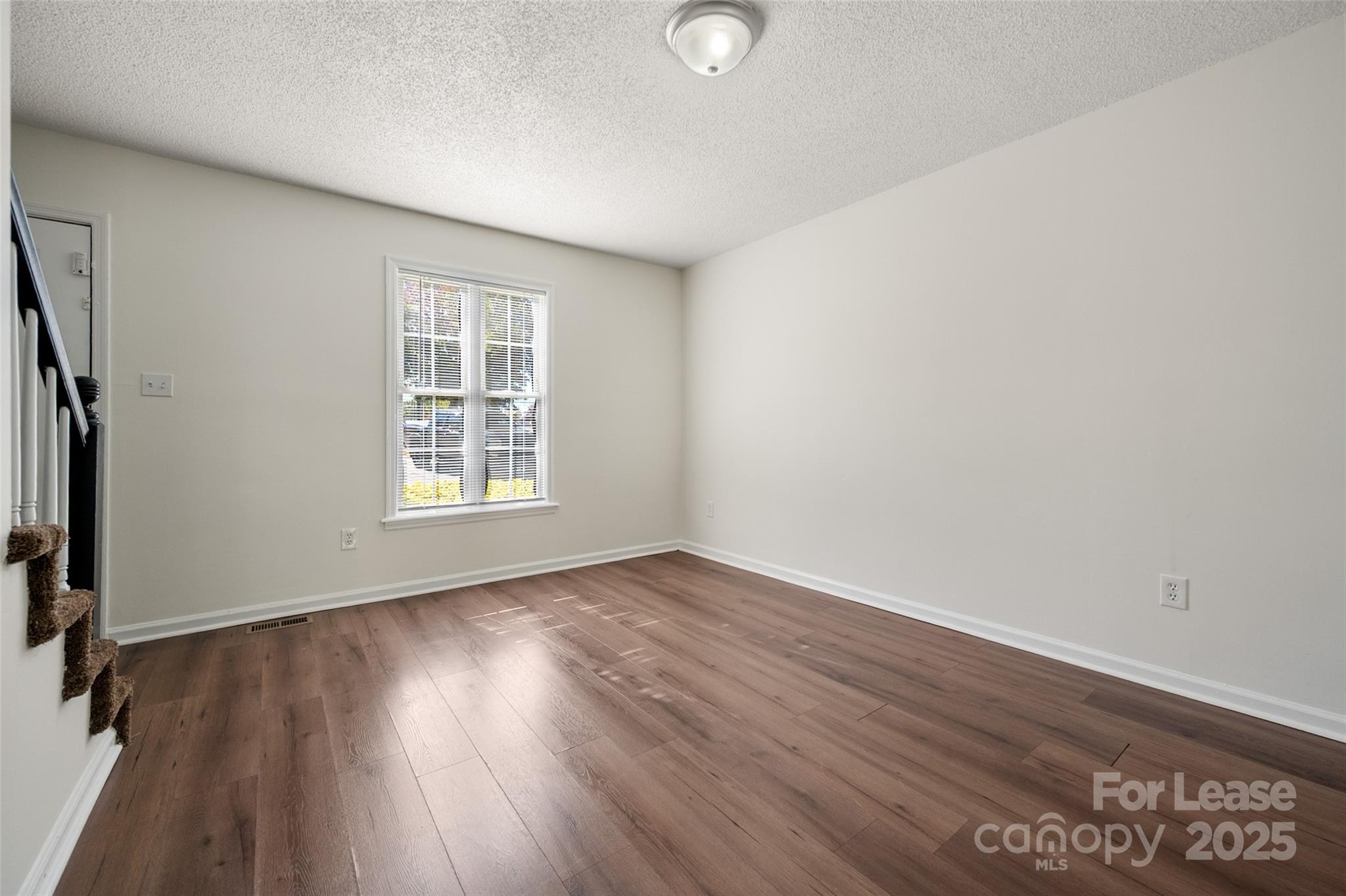 608 Bethpage Road Kannapolis, NC 28081 - Photo 5 of 37 an empty room with wooden floor and windows