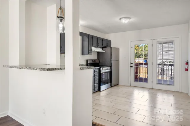 a view of a kitchen with a refrigerator cabinet and a window