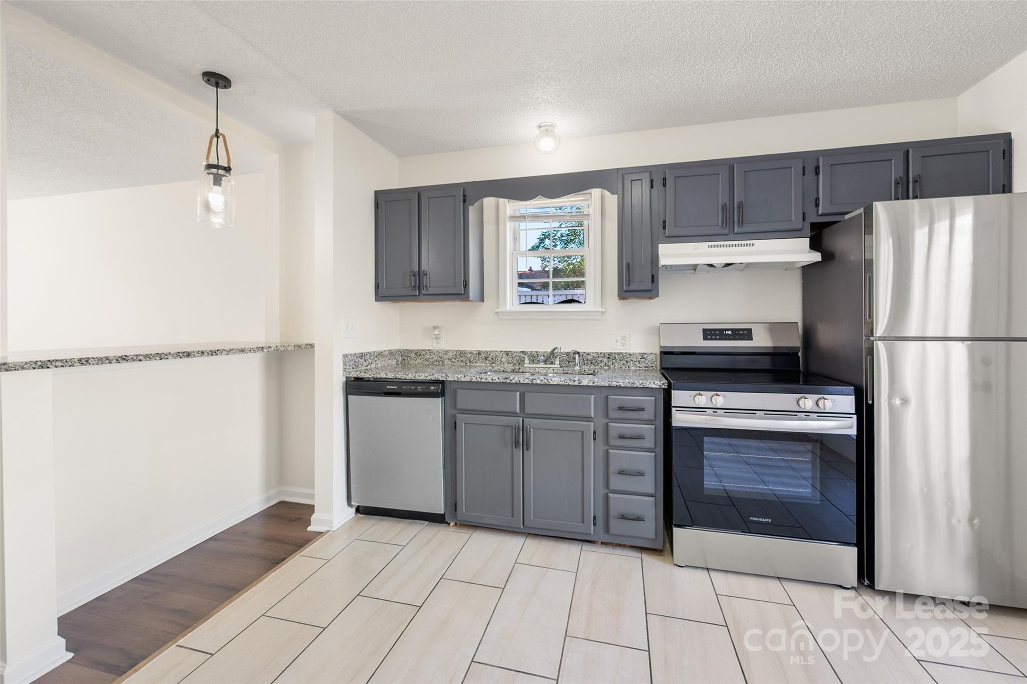 608 Bethpage Road Kannapolis, NC 28081 - Photo 10 of 37 a kitchen with kitchen island granite countertop a refrigerator oven a sink and dishwasher
