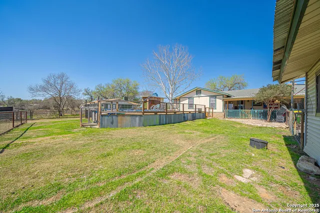 a swimming pool with yard and outdoor seating