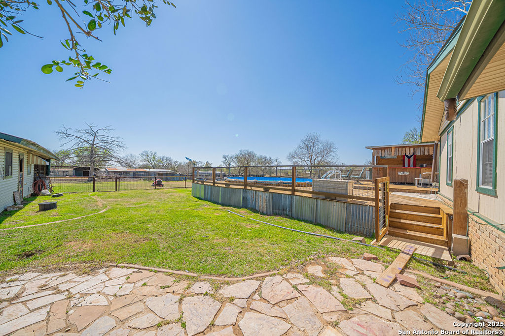 10544 Macaway Road Adkins, TX 78101 - Photo 14 of 40 a swimming pool with yard and outdoor seating