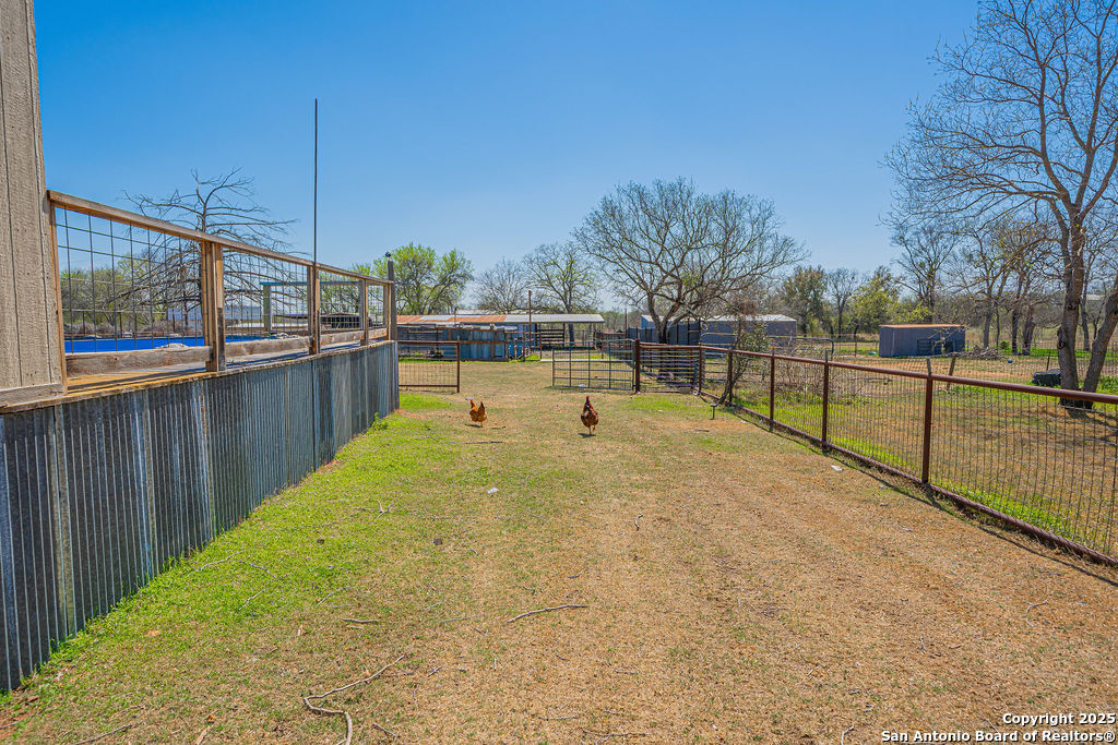 10544 Macaway Road Adkins, TX 78101 - Photo 26 of 40 a view of a swimming pool with a chair and floor