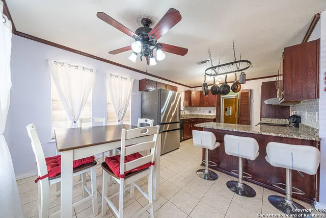 a kitchen with stainless steel appliances granite countertop a stove a sink dishwasher a refrigerator and a oven