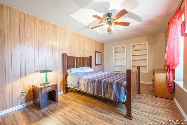 a bathroom with a granite countertop sink mirror vanity and toilet