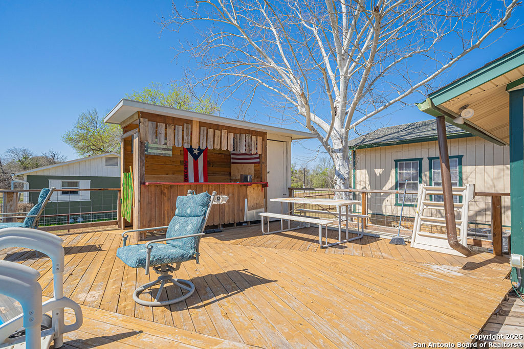 10544 Macaway Road Adkins, TX 78101 - Photo 7 of 40 a view of a patio with a table chairs and balcony