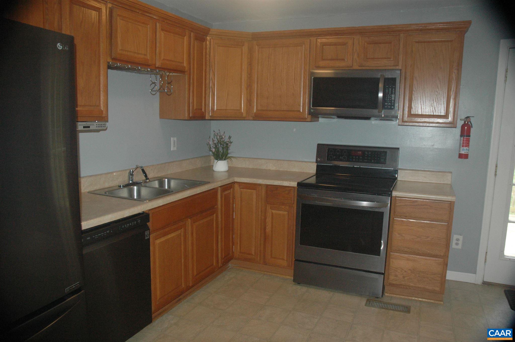 3396 Cedar Lane Road Kents Store, VA 23084 - Photo 20 of 50 a kitchen with a sink and steel appliances