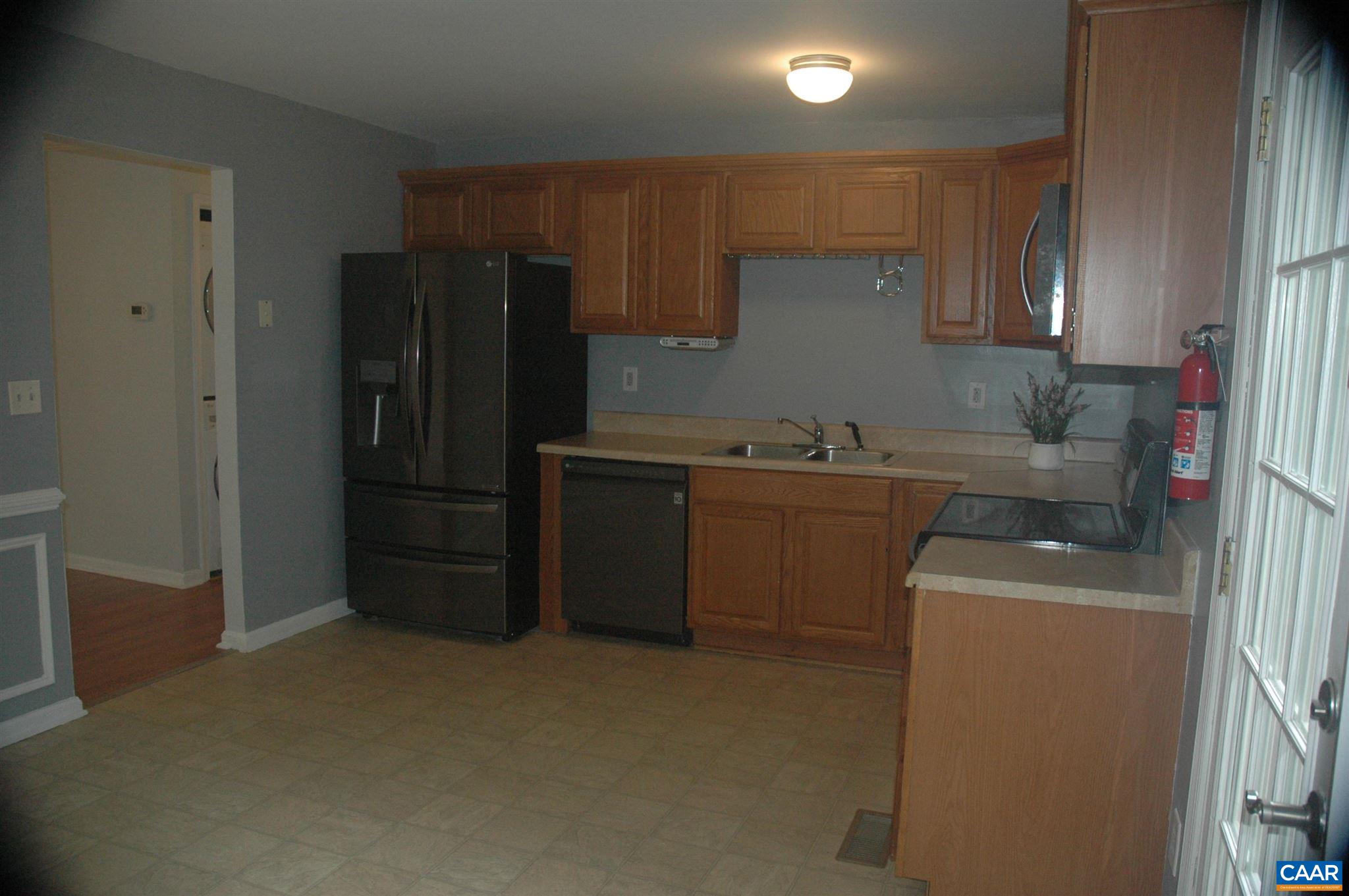 3396 Cedar Lane Road Kents Store, VA 23084 - Photo 26 of 50 a kitchen with a refrigerator sink and cabinets