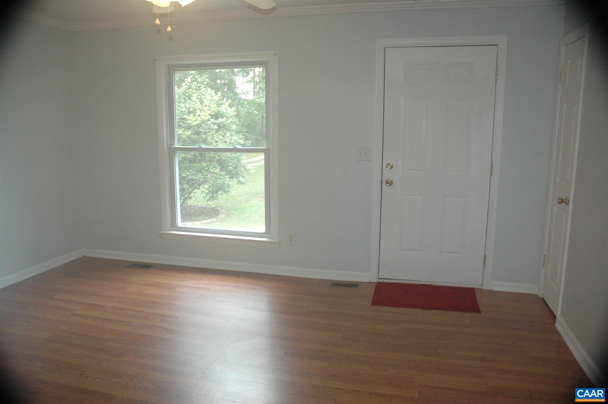 3396 Cedar Lane Road Kents Store, VA 23084 - Photo 27 of 50 an empty room with wooden floor and windows