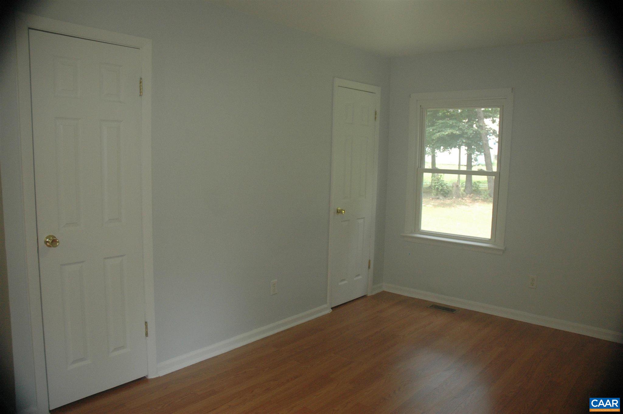 3396 Cedar Lane Road Kents Store, VA 23084 - Photo 31 of 50 an empty room with wooden floor and windows