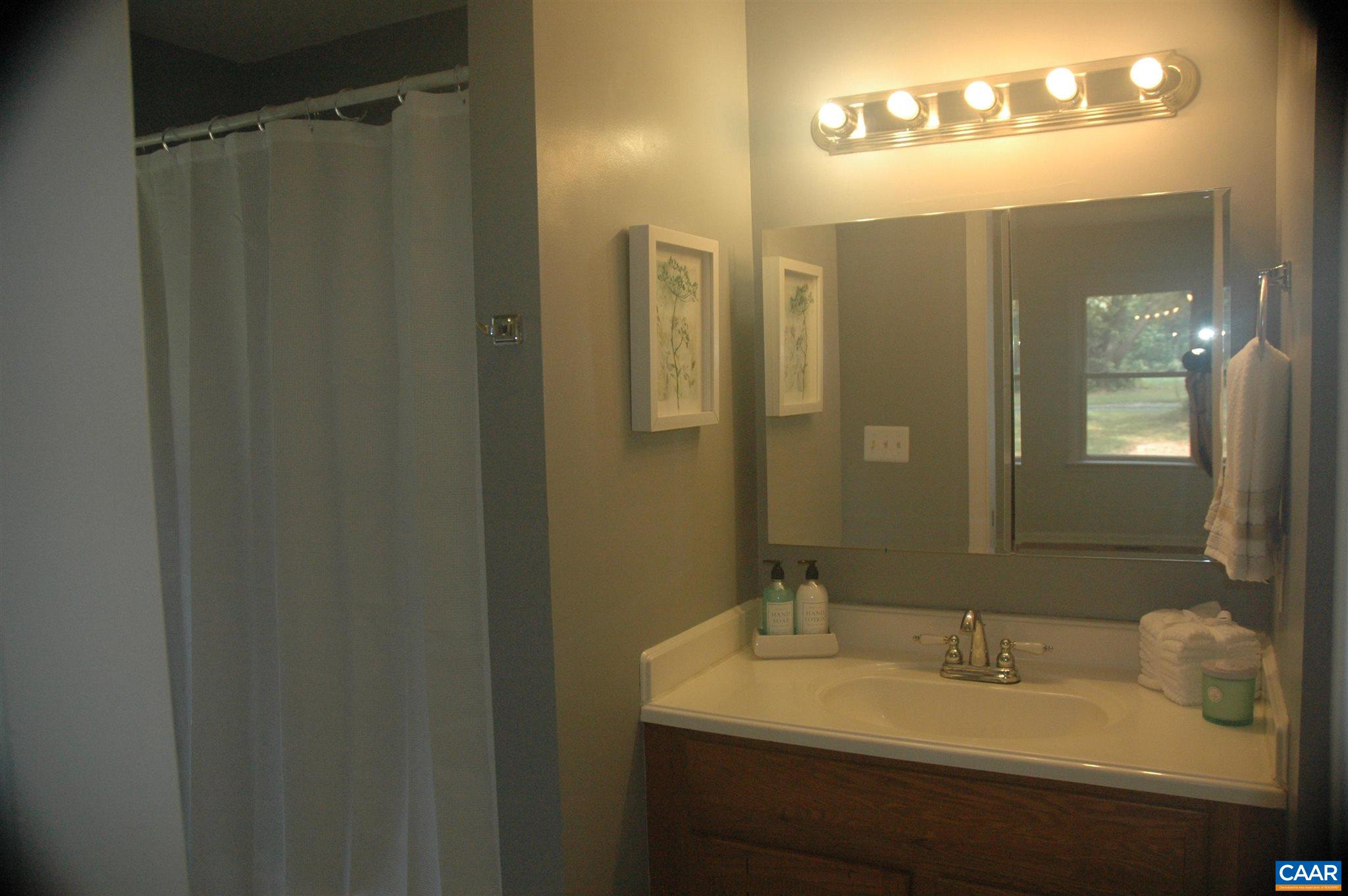 3396 Cedar Lane Road Kents Store, VA 23084 - Photo 35 of 50 a bathroom with a sink and mirror