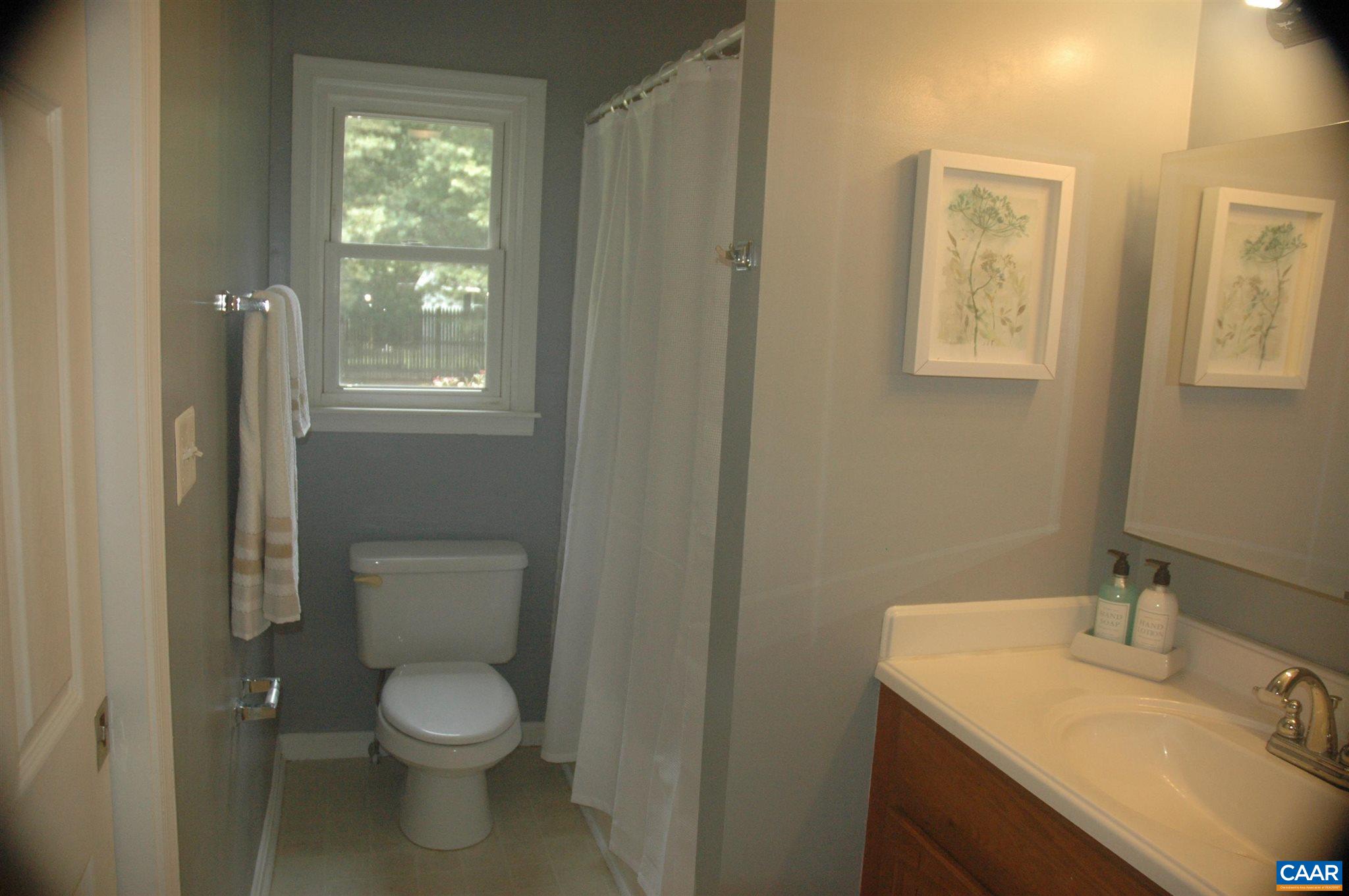 3396 Cedar Lane Road Kents Store, VA 23084 - Photo 36 of 50 a bathroom with a toilet sink and mirror