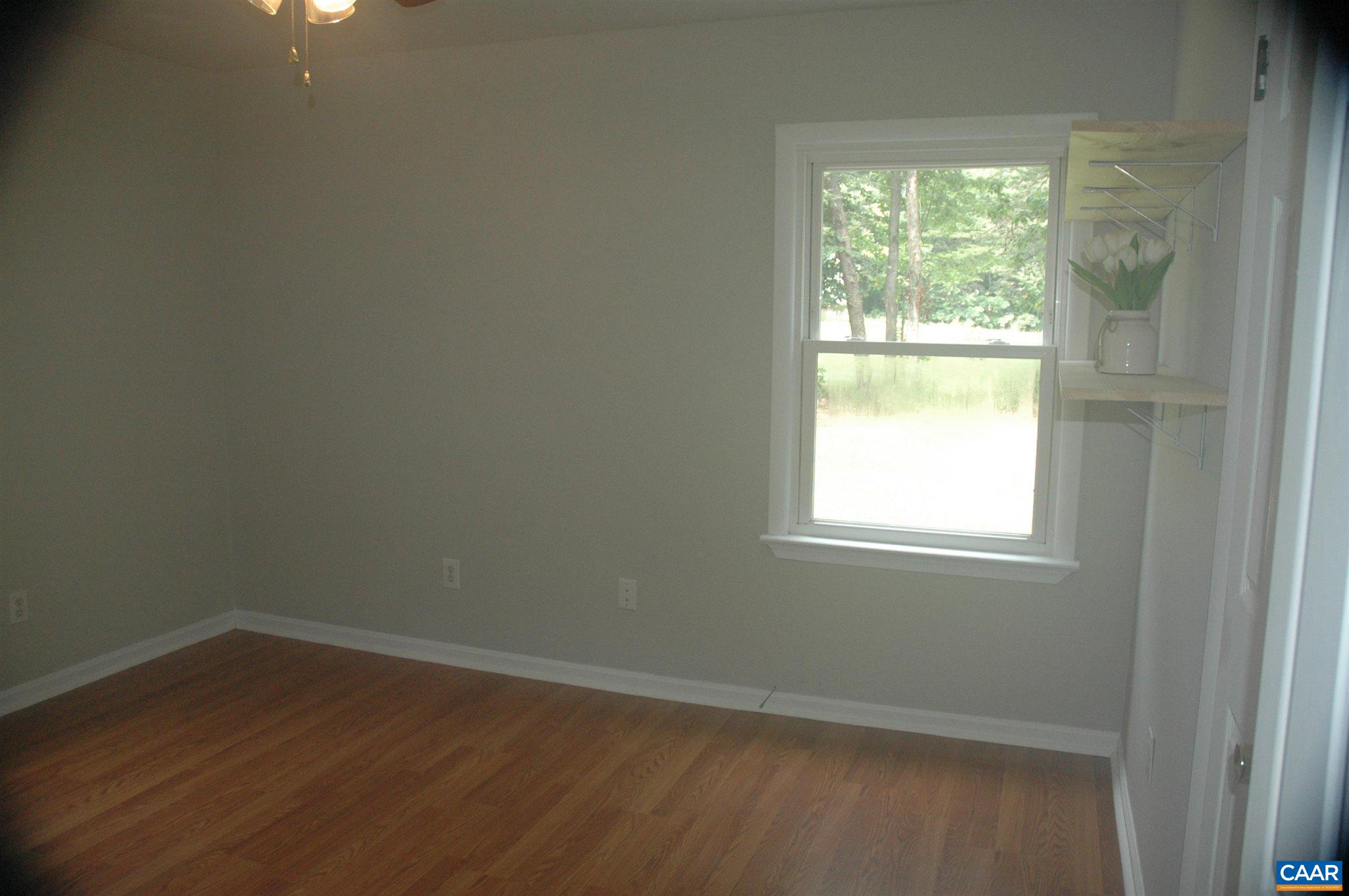 3396 Cedar Lane Road Kents Store, VA 23084 - Photo 40 of 50 an empty room with wooden floor and windows