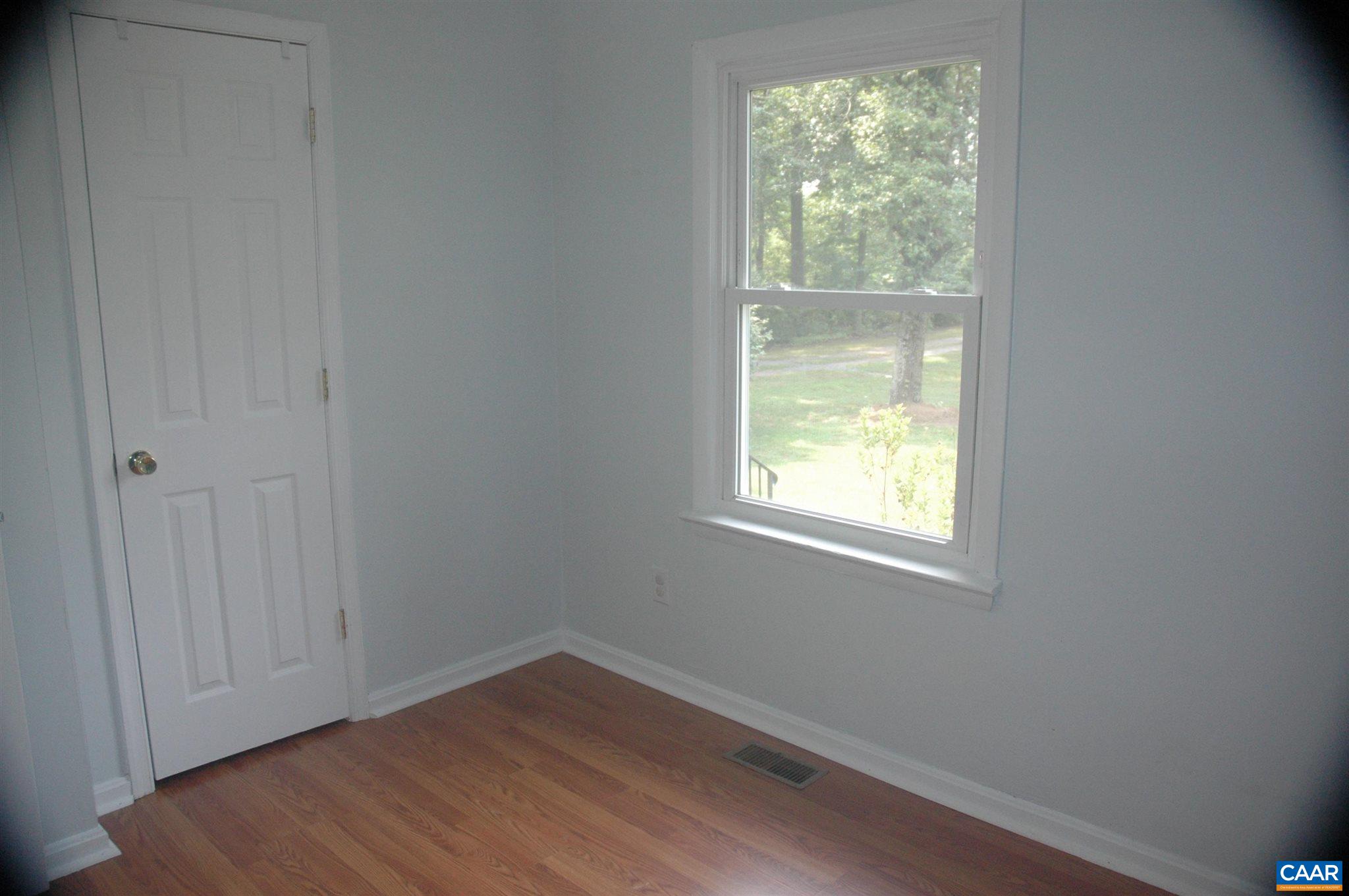 3396 Cedar Lane Road Kents Store, VA 23084 - Photo 45 of 50 an empty room with wooden floor and windows
