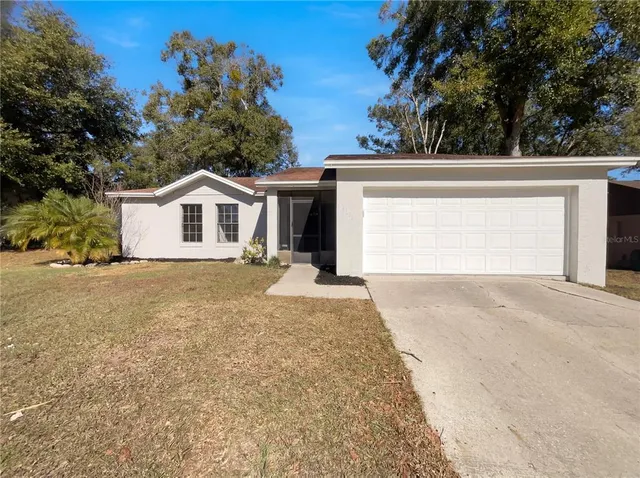 a view of a house with a yard and garage