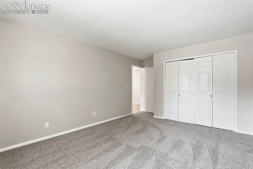 240 Bennington Drive Colorado Springs, CO 80906 - Photo 25 of 44 This interior space features light grey walls and a grey patterned carpet