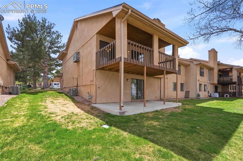 240 Bennington Drive Colorado Springs, CO 80906 - Photo 33 of 44 The property features a private patio, a second-story balcony with railings, and a stucco exterior