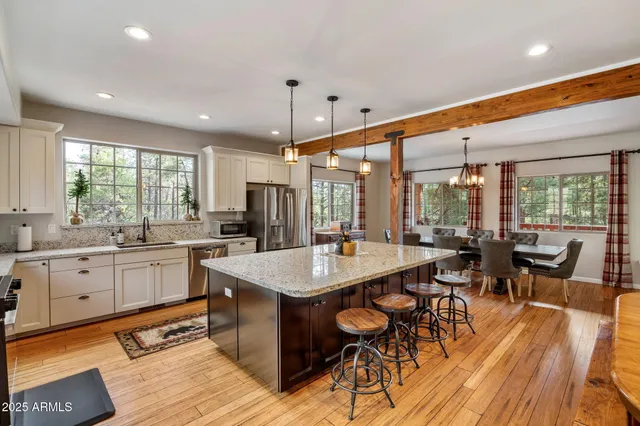 a kitchen with sink table and chairs